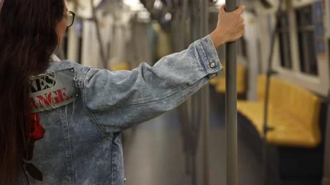 Model is posing in carriage of metro train Stock Footage 233636635