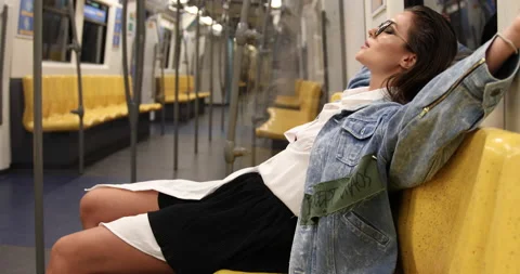 Model is posing in carriage of metro train Stock Footage 233640732