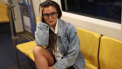 Model is posing in carriage of metro train Stock Footage 233640987