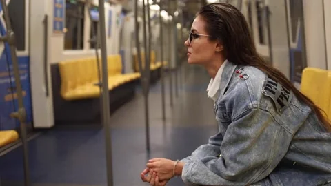 Model is posing in carriage of metro train Stock Footage 233641069