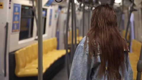 Model is posing in carriage of metro train Stock Footage 233641309