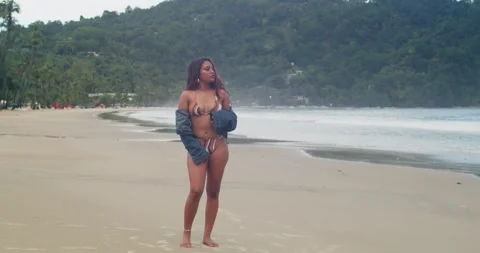 Model posing casually in bikini on scenic tropical coastline. Video stock 347182734