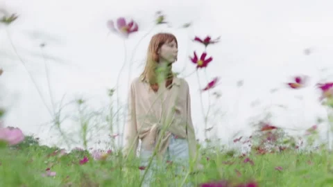 Model posing in cosmos flower field Video stock 314981766