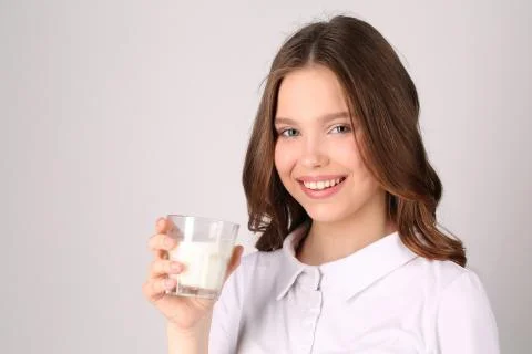 Model posing with glass of milk. Close up. White background Stock Photos