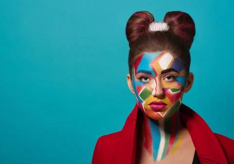 Model posing, has funky, colorful make up on face. Stock Photos