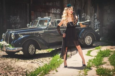 Model posing near retro-styled car Stock Photos