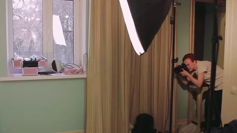 Model posing for photographer in hotel room Stock Footage 80117875