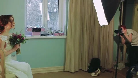 Model posing for photographer in hotel room Stock Footage 80222577