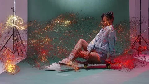 Model posing on skateboard, gold sparkles entering right sweeping over subject Stock Footage 332867117