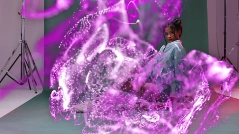Model posing on skateboard in studio magenta flow appearing from left, Stock Footage 332981649