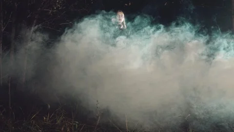 Model posing in smoke during nighttime p... | Stock Video | Pond5