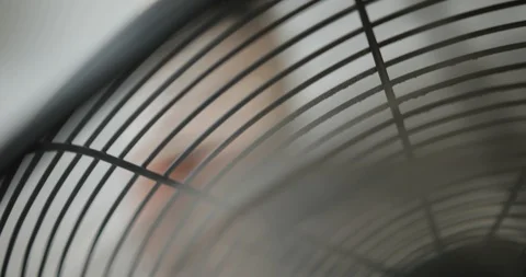 Model posing in the studio. Look from behind the fan at pretty model in short Stock Footage 100362079