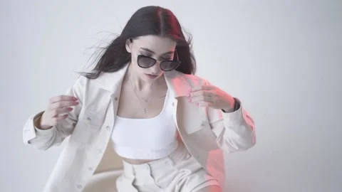 Model posing with sunglasses  in studio Stock Footage 157444921
