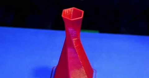 Model is printed on the 3D printer close. 3D printer printing object red color Stock Footage 149998908