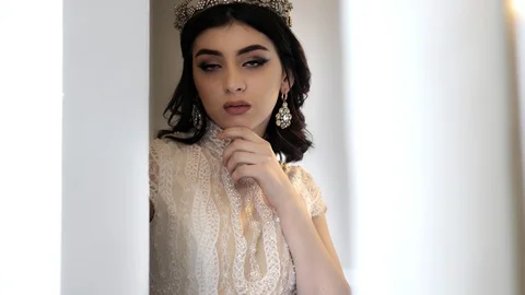 Model with professional makeup stands and looks at camera Stock Footage 107960588