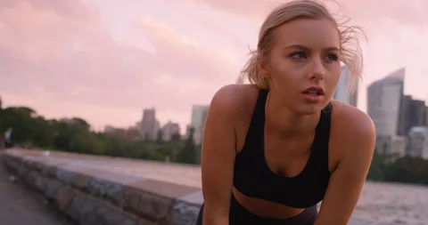 Model puffed at sunset with city back drop Stock Footage 102471986