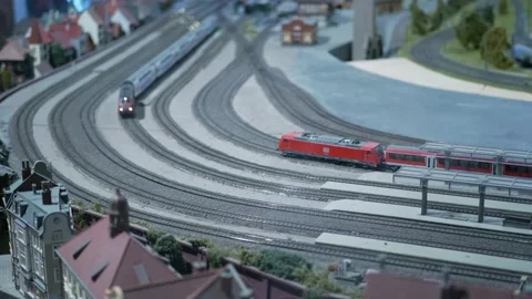 Model of railway station. Model of train with steam moving on model railroad Stock Footage 151995194
