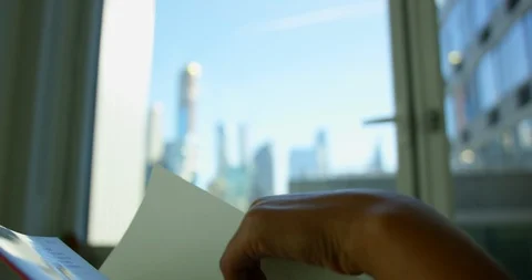Model Reading Interesting Book From Her Apartment Looking Out At NYC Skyline Stock Footage 111875745