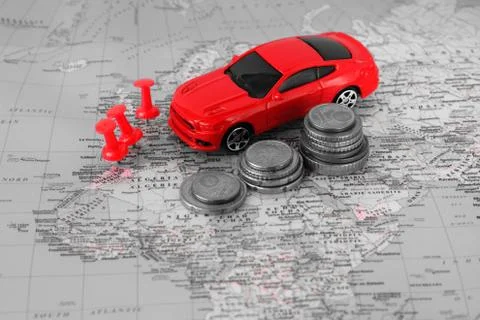 Model red car on  background of  geographical map and coins of euro cents. Stock-Fotos