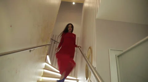 Model In A Red Dress Posing On The Stairs Stock Footage 52006469