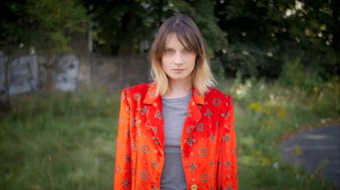 Model with red jacket posing and smiling in camera Stock Footage 59737170