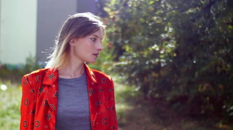 Model with red jacket posing and smiling in camera Stockbeeldmateriaal 59737835