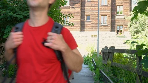 Model Released - Happy attractive young man exploring city with backpack Stock Footage 93182024