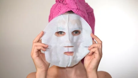 Model removing mask from face Stock Footage 224484326