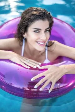 Model in rubber ring in swimming pool 스톡 사진