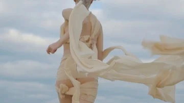 Model running on a cloudy day on beach Stock-Footage 85740806