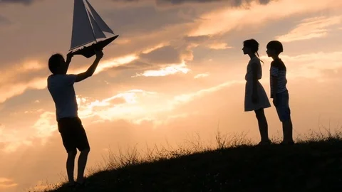 Model of a sailboat. The man is holding a ship model against the sky.  Stock Footage 79113777