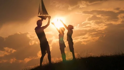 Model of a sailboat. A man is holding a ship model against the sky. Stock Footage 79114654
