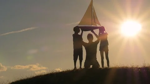 A model of a sailboat. A man is holding a ship model against the sky. The father Stock Footage 80319410
