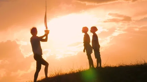 A model of a sailboat. A man is holding a ship model against the sky. The father Stock Footage 80321182