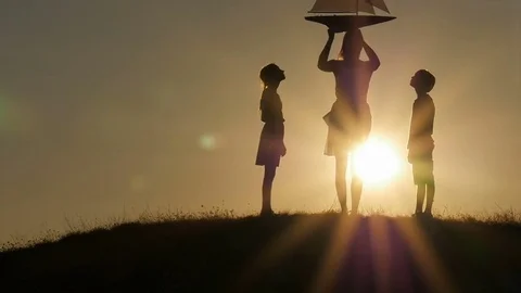 Model of a sailboat. Mom holds a model of the ship in her hands. The children ar Stock Footage 80320349