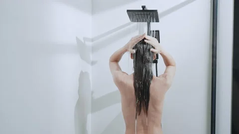 Model showering in bathroom Stock Footage 200993363