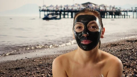 Model sits on the background of beach and sea and enjoys drinking wine. Beaut Stock Footage 96043080