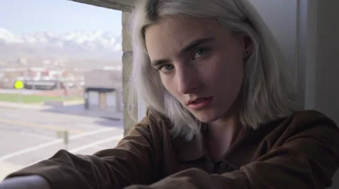 Model Sits In Window And Looks At Camera, Flirtatious Stock Footage 62364255