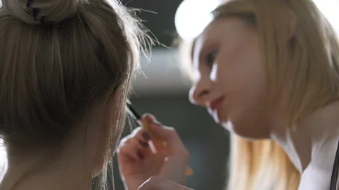 Model sitting near the mirror during the make up process. View from back. Stock Footage 121509919
