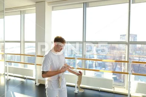 Model in sportswear diligently rock press in hall with big windo Stock Photos