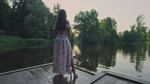  A model stands close to a river Stock Footage 156508768