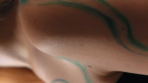 The model stands in the studio and shows a tattoo Stock Footage 184078048