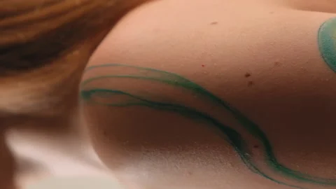 The model stands in the studio and shows a tattoo Stock Footage 184082051