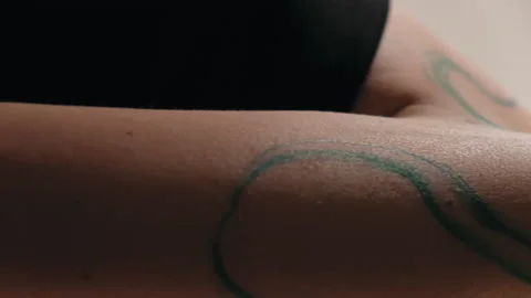 The model stands in the studio and shows a tattoo Video stock 184083849