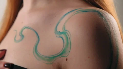 The model stands in the studio and shows a tattoo Stock Footage 184084556