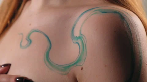 The model stands in the studio and shows a tattoo Stock Footage 184090914