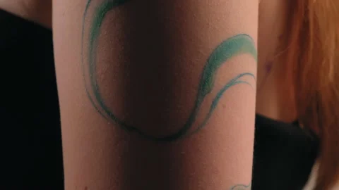 The model stands in the studio and shows a tattoo Stock Footage 184097133