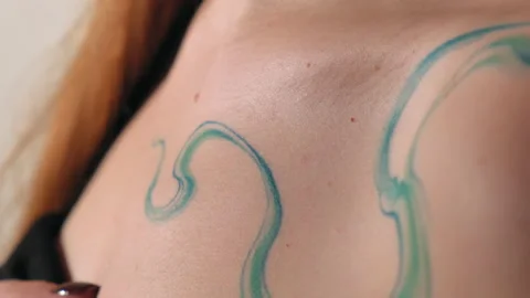 The model stands in the studio and shows a tattoo Stock Footage 184102924