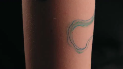 The model stands in the studio and shows a tattoo Stock Footage 184109565