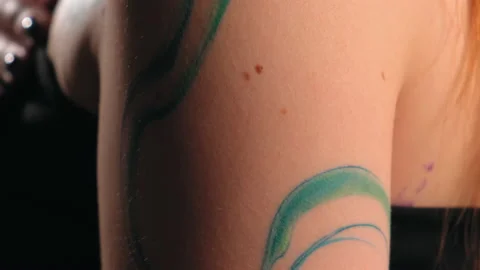 The model stands in the studio and shows a tattoo Video stock 184254194